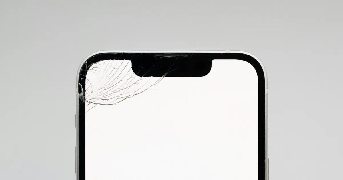 iPhone with a cracked screen on a white background