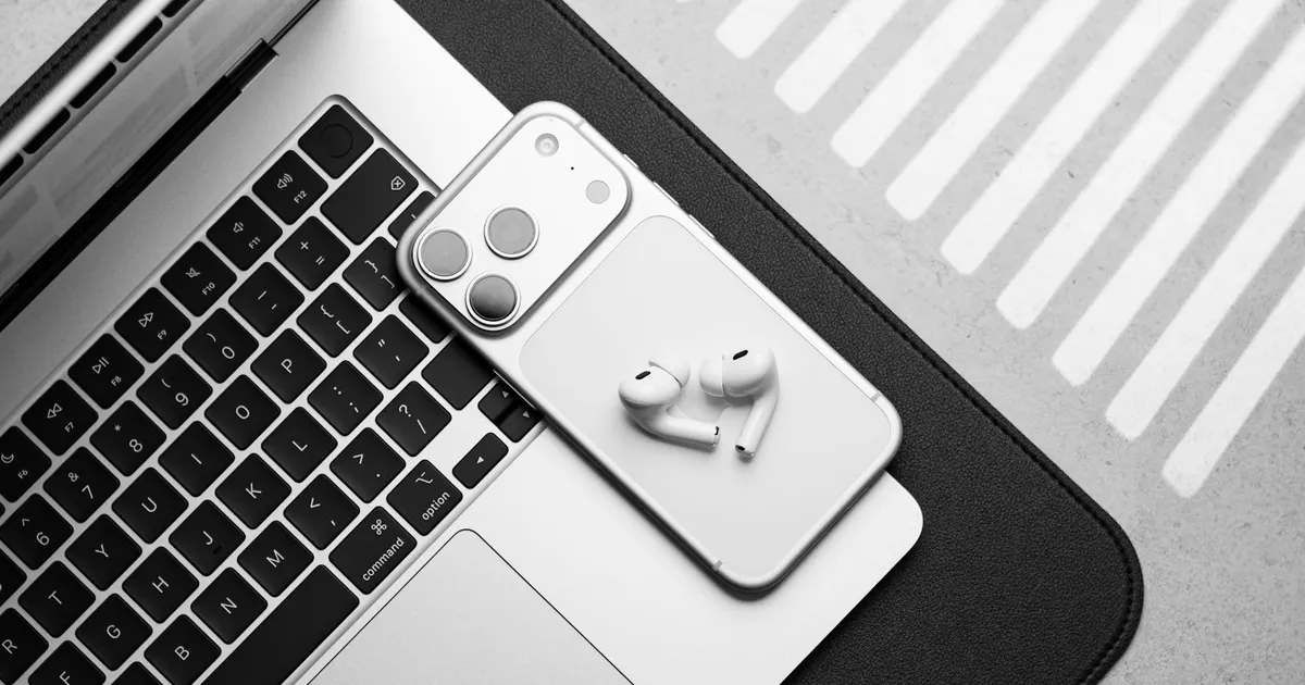 MacBook, iPhone and AirPods on a workdesk — the Apple devices repaired at iFix Guwahati
