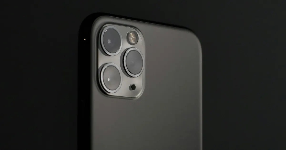 Rear glass panel of a dark iPhone with camera module