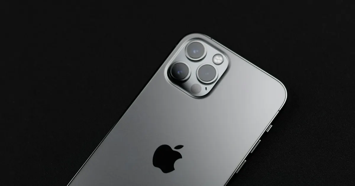 Silver iPhone lying on a dark surface