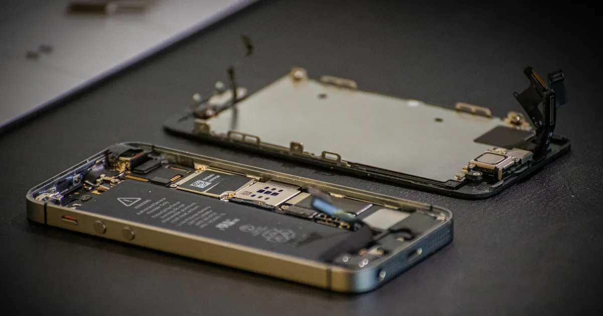 Opened iPhone showing its logic board and internal components
