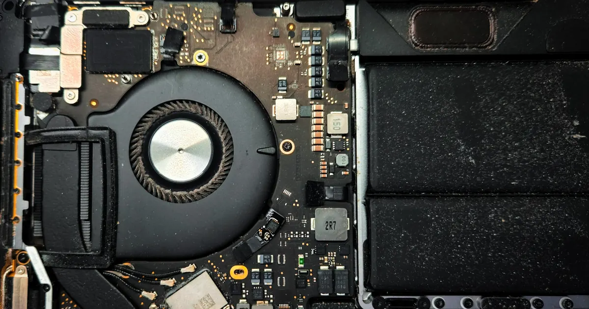 Opened MacBook interior showing the cooling fan and logic board