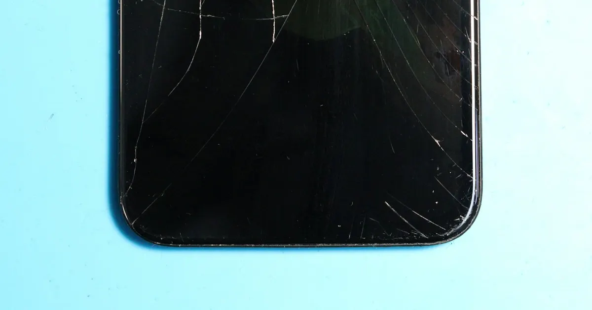 Smartphone with a shattered cracked screen awaiting display replacement